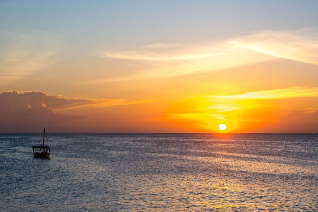 Traditional dhow sailing at sunset in Zanzibar