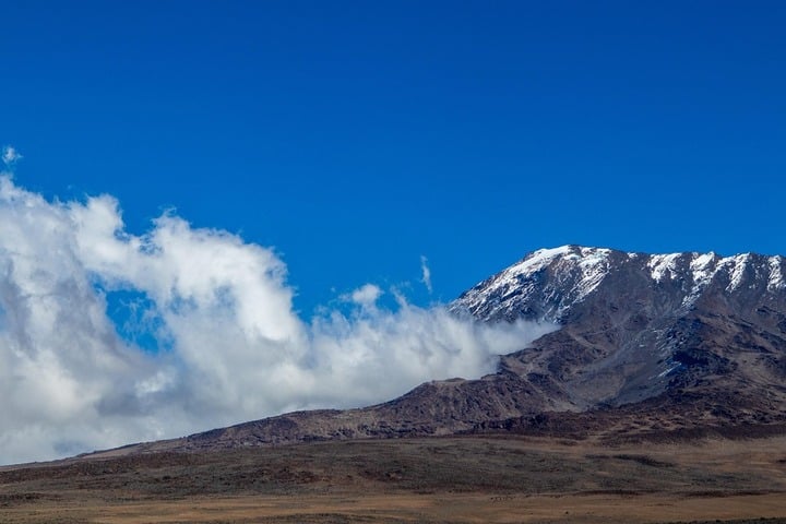 Mount Kilimanjaro snow-capped summit rising above the clouds in Tanzania