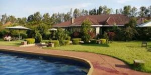 Bougainvillea Safari Lodge exterior showing cozy cottages surrounded by gardens in Karatu, Tanzania
