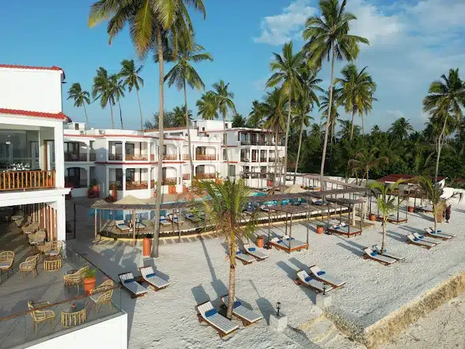 Interior of a Dream of Zanzibar resort room with ocean view balcony and elegant furnishings